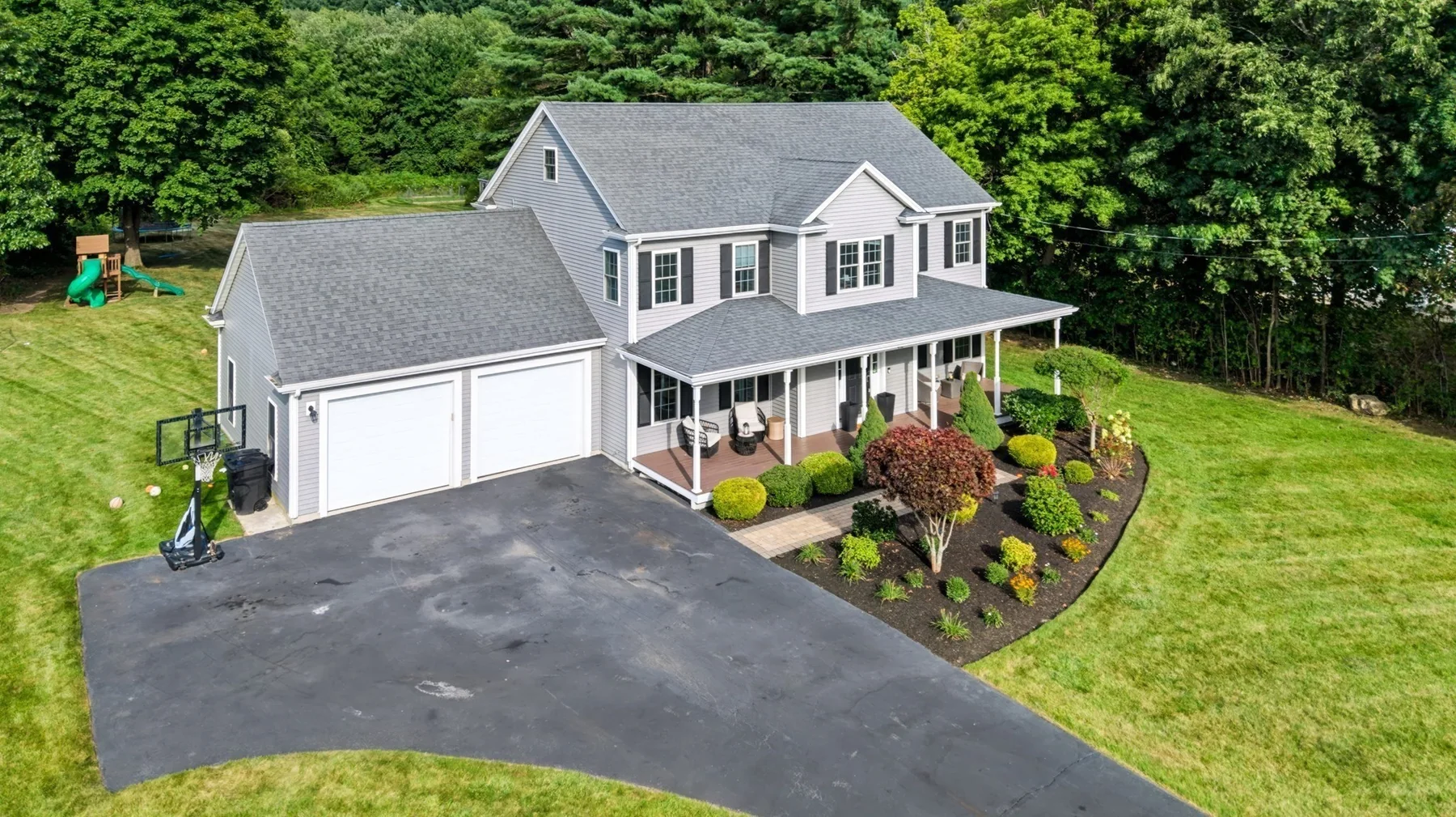 Aerial view of the home and landscaped front approach